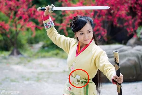 Phân cảnh múa kiếm sẽ đẹp và hoàn hảo nếu như Nhạc Linh San trong Tân Tiếu Ngạo Giang Hồ 2012 không giấu hẳn điện thoại vào thắt lưng như thế này.