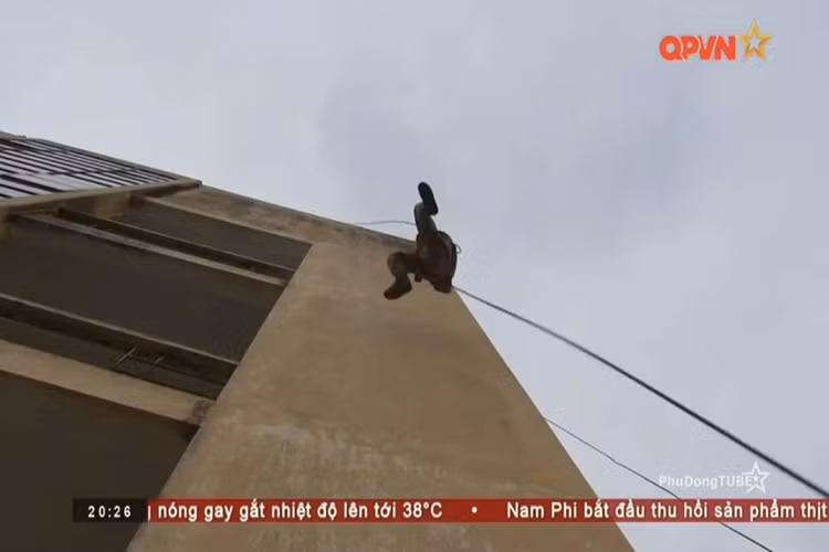 Hình ảnh nữ chiến sĩ đặc công Lữ đoàn 113 đu mình xuống mặt đất từ độ cao hàng chục mét chỉ trong chớp trong một nội dung huấn luyện chiến thuật đối với các mục tiêu cao tầng. Nguồn ảnh: QPVN.