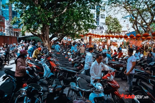 Được biết, cúng chư thiên tại chùa Ngọc Hoàng đã trở thành hoạt động truyền thống vào đúng mồng 9 Tết với mong ước có được một cuộc sống ấm no, sung túc của người Sài Gòn. Ảnh: Bãi xe bên trong chùa đã chật kín ngay từ sáng sớm, tận trưa mọi người đều buộc phải gửi xe nhà dân.