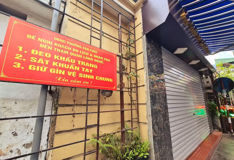 Để phòng chống dịch bệnh COVID-19, UBND phường sở tại treo nhiều tấm biển thông báo xung quanh làng lụa Vạn Phúc, yêu cầu khách và nhân dân phải đeo khẩu trang, sát khuẩn, giữ vệ sinh chung khi đến đây.