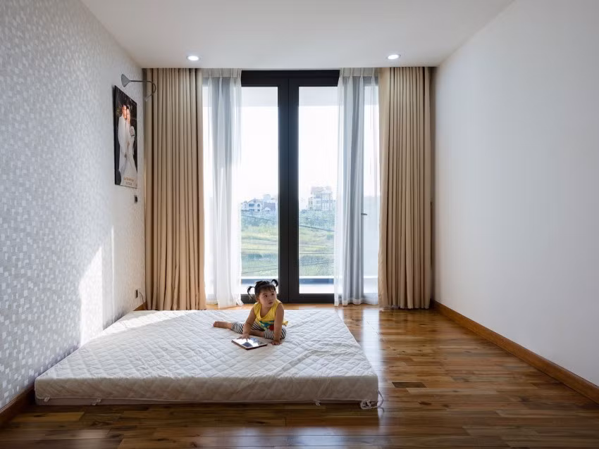  Phòng ngủ thoáng, ngập nắng nhờ cửa kính lớn.