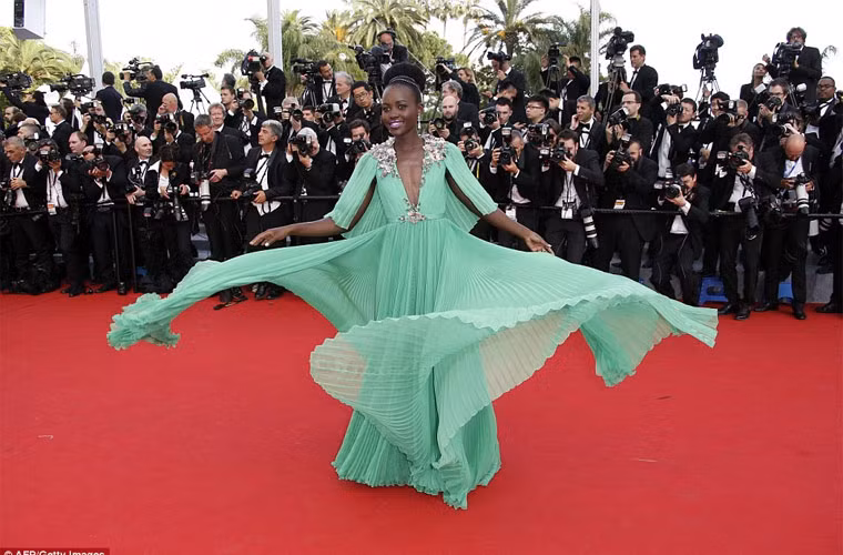 Ngôi sao Hollywood Lupita Nyong'o nổi bật với chiếc váy Gucci màu xanh ngọc với kiểu tạo dáng xòe váy quen thuộc.