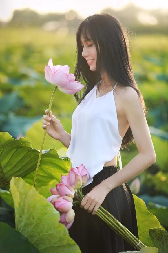 Trên trang cá nhân, ca sĩ chuyển giới Lynk Lee gây chú ý khi tung loạt ảnh mặc yếm, áo dài chụp bên ao sen.