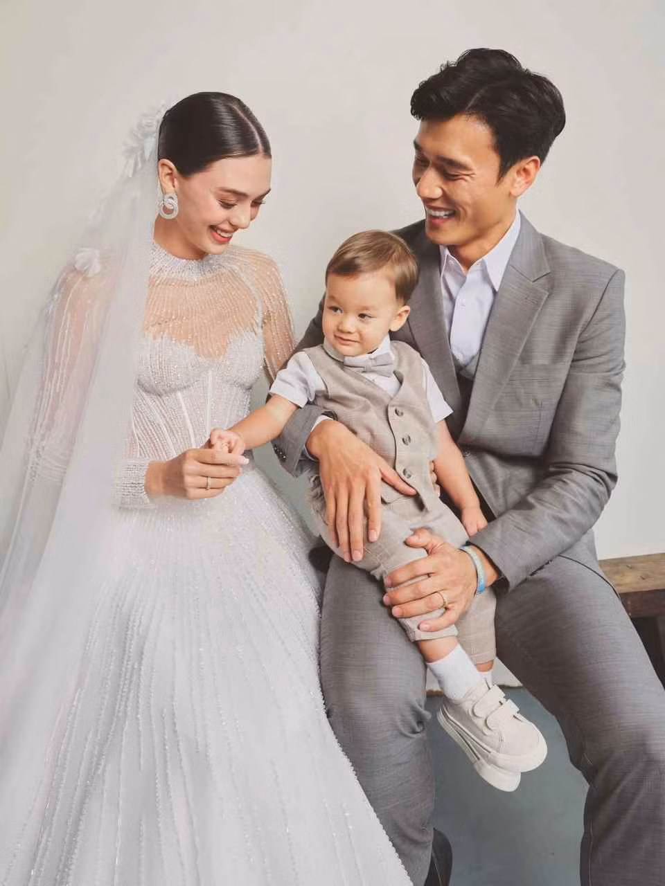 Trong hình, người mẫu mặc váy cưới chất liệu xuyên thấu gợi cảm, trong khi Bùi Tiến Dũng bảnh bao với vest.
