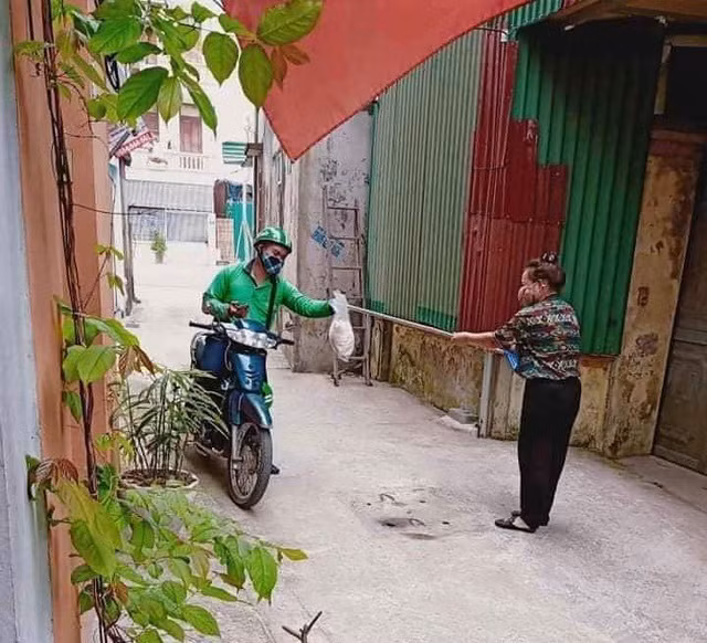 Để đảm bảo khoảng cách an toàn với khách trong mùa dịch một chàng tài xế xe ôm có kèm dịch vụ giao hàng đã chủ động nhờ khách dùng gậy để đưa hàng cho mình.