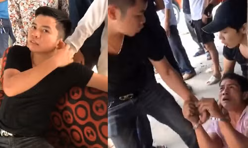 Nhóm thanh niên (áo đen) giả danh công an huyện Quốc Oai (Hà Nội) bắt giữ, còng tay người đàn ông trung tuổi. Ảnh cắt từ clip.