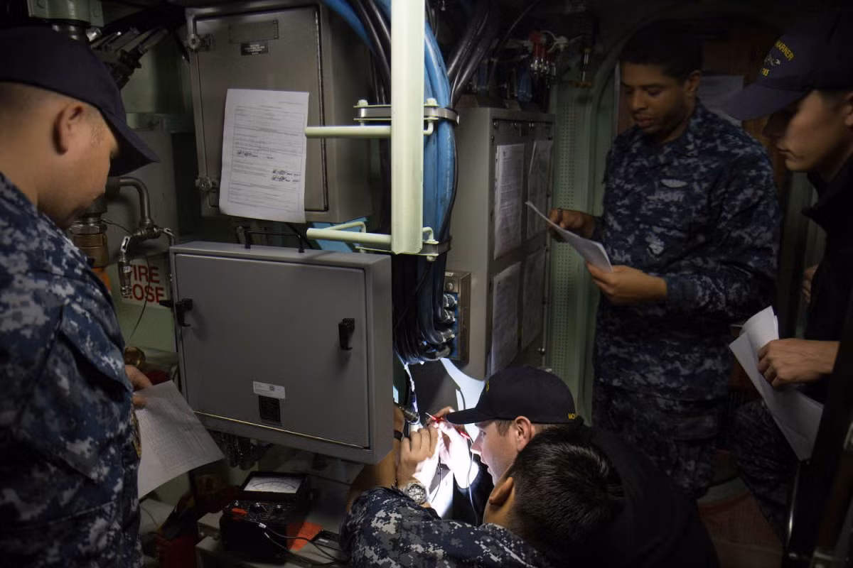 Một đội bảo trì đang kiểm tra hệ thống điện trên tàu ngầm nguyên tử USS John Warner. Nguồn ảnh: BI.