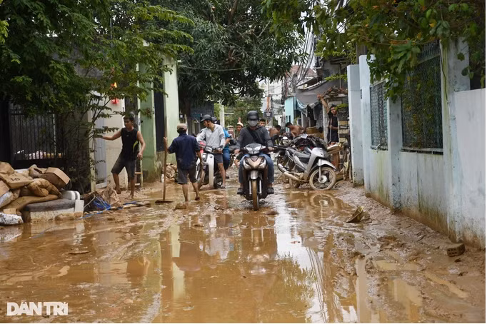 Dòng nước luồn vào các con hẻm trên tuyến đường Mẹ Suốt mang theo lớp bùn đất dày (Ảnh: Quốc Triều).