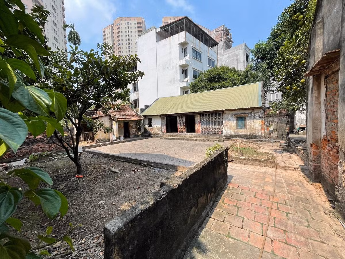 Ngôi nhà được xây dựng cách đây gần 80 năm, nằm trên khu đất rộng 200m2. Căn nhà được che lấp bởi những ngôi nhà cao tầng kiên cố. Ảnh: Người đưa tin