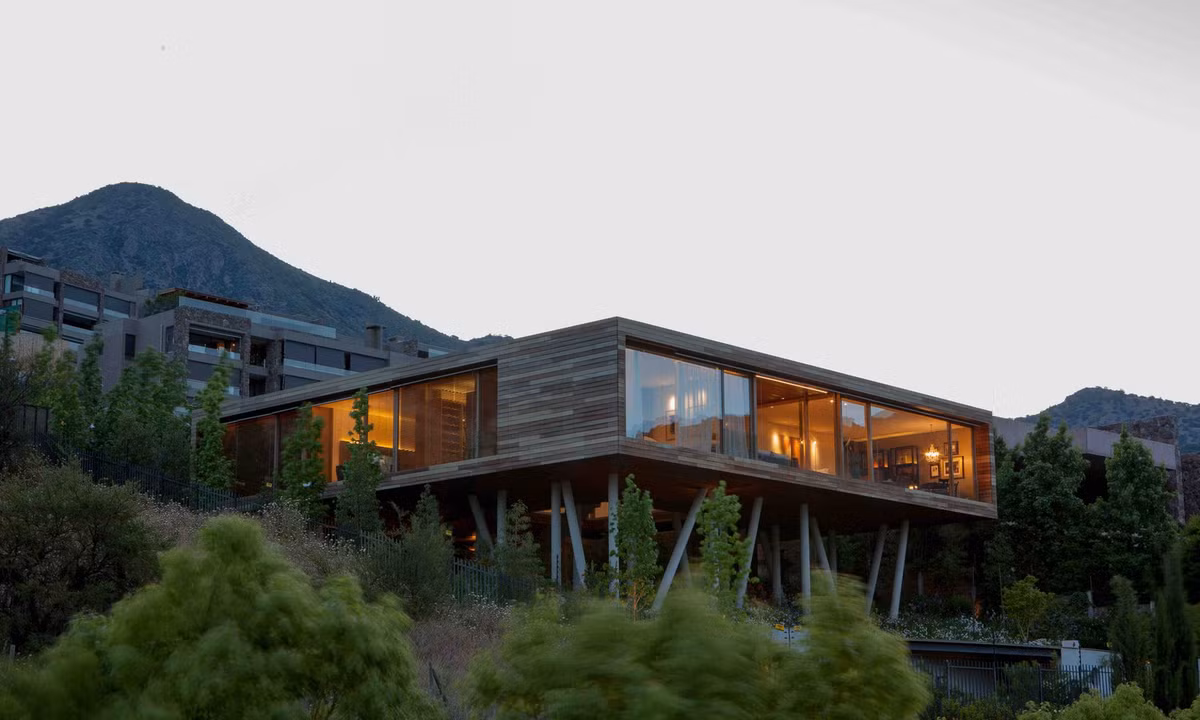 Dưới chân đồi Manquehue ở Chile, Esmeralda House nằm trên độ dốc xấp xỉ 30 độ. Khối nhà chính được thiết kế “nằm lơ lửng” trên một hệ thống cột bê tông đảm nhiệm chức năng kép, vừa giúp cân bằng mặt sàn, vừa chịu tải lực cho toàn bộ ngôi nhà.