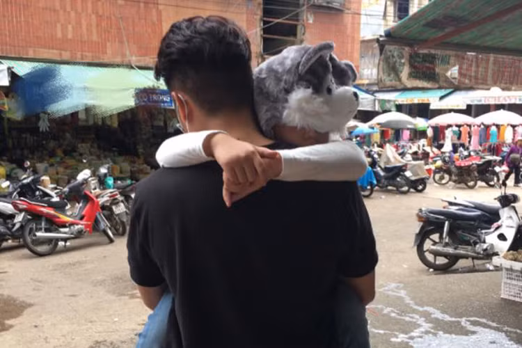 Bé Cà Pháo ngủ ngon lành trên vai của bố dượng.