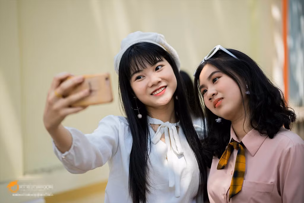 Các bạn nữ hào hứng lưu giữ khoảnh khắc thanh xuân trong trang phục áo sơ mi trắng và chân váy sẫm màu.