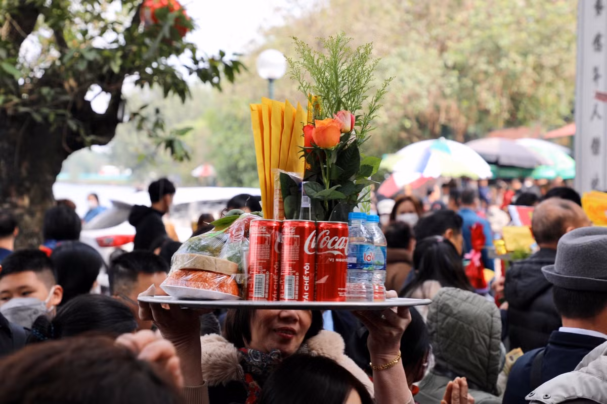 Nhiều người phải dâng cao lễ lên đầu để tránh va phải người xung quanh.