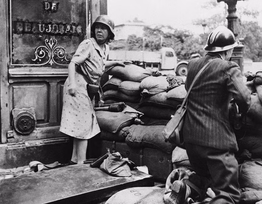 Nữ du kích Pháp đang chiến đấu trên đường phố Paris vào tháng 8/1944, bà đeo bên hông một khẩu súng lục của sỹ quan Đức và sử dụng lựu đạn của Đức trong cuộc chiến giành vị trí mở đường cho quân Đồng Minh tiến vào giải phóng Paris. Ảnh: Theatlantic.