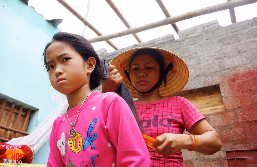 Cuộc sống của gia đình chị Bình (thôn Đồng Nghiêm) đảo lộn khi mái nhà không còn. "Tôi vẫn còn sợ hãi, ăn ngủ không yên. Lốc kèm mưa đá kéo dài đến hơn 30 phút. Tôi với các con và mẹ già tối qua chỉ biết trốn dưới gầm giường rồi ôm nhau khóc", chị Bình nói. Ảnh: Zingnews.
