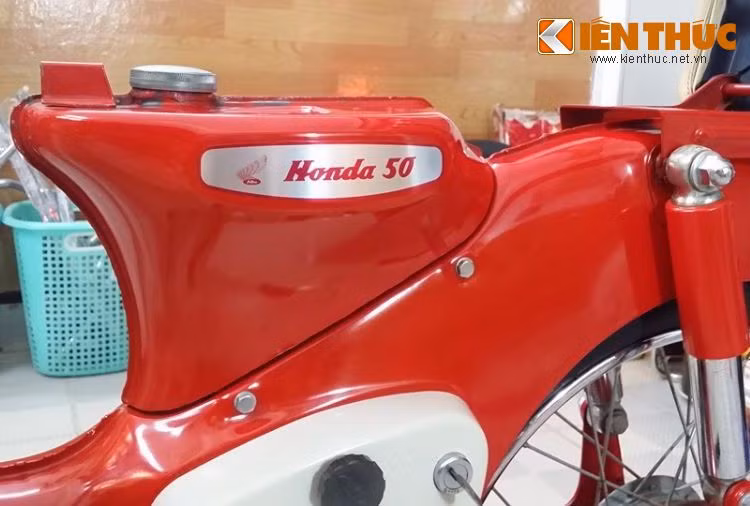 Tem dán trên bình xăng với dòng chữ Honda 50 vẫn còn óng ánh màu kim loại phay xước. Cũng giống như bộ giò gà trước của chiếc xe, lớp sơn đỏ ở thân xe vẫn còn giữ được độ bóng sau nhiều năm.