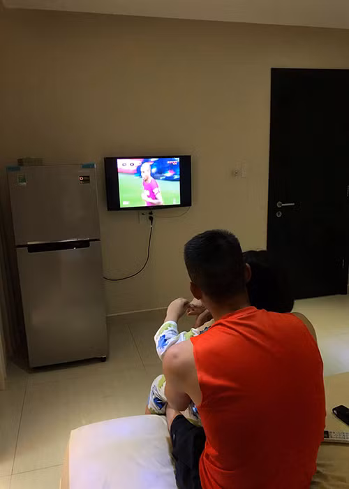 Công Vinh luôn cưng chiều con gái hết mực. Trong ảnh, anh ôm con gái vào lòng khi cả hai xem tivi.