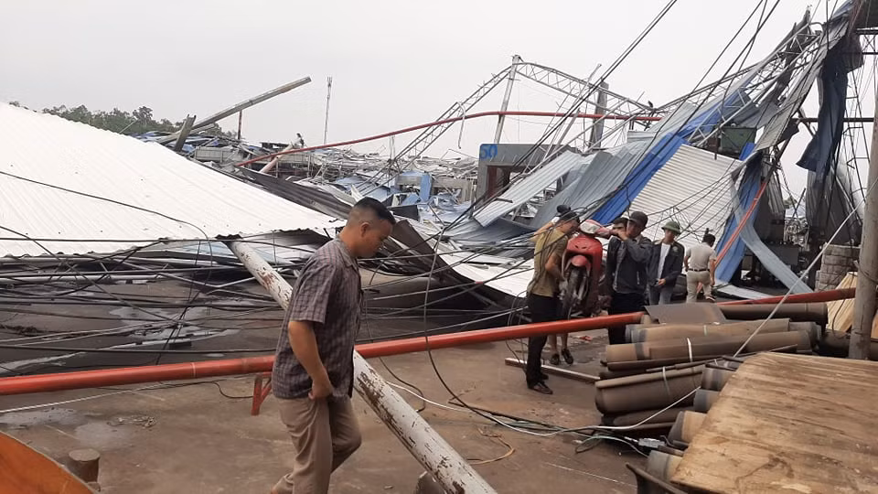 Người dân chỉ còn biết đứng nhìn những nhà xưởng trơ trụ bởi cơn giông lốc.