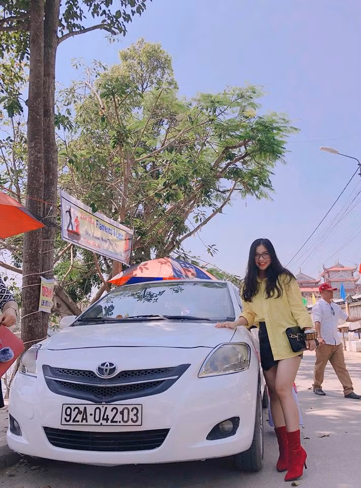 Nhật Lê diện áo sơ mi vàng, váy đen và boot đỏ đi du xuân với mong muốn năm mới sẽ rực rỡ.