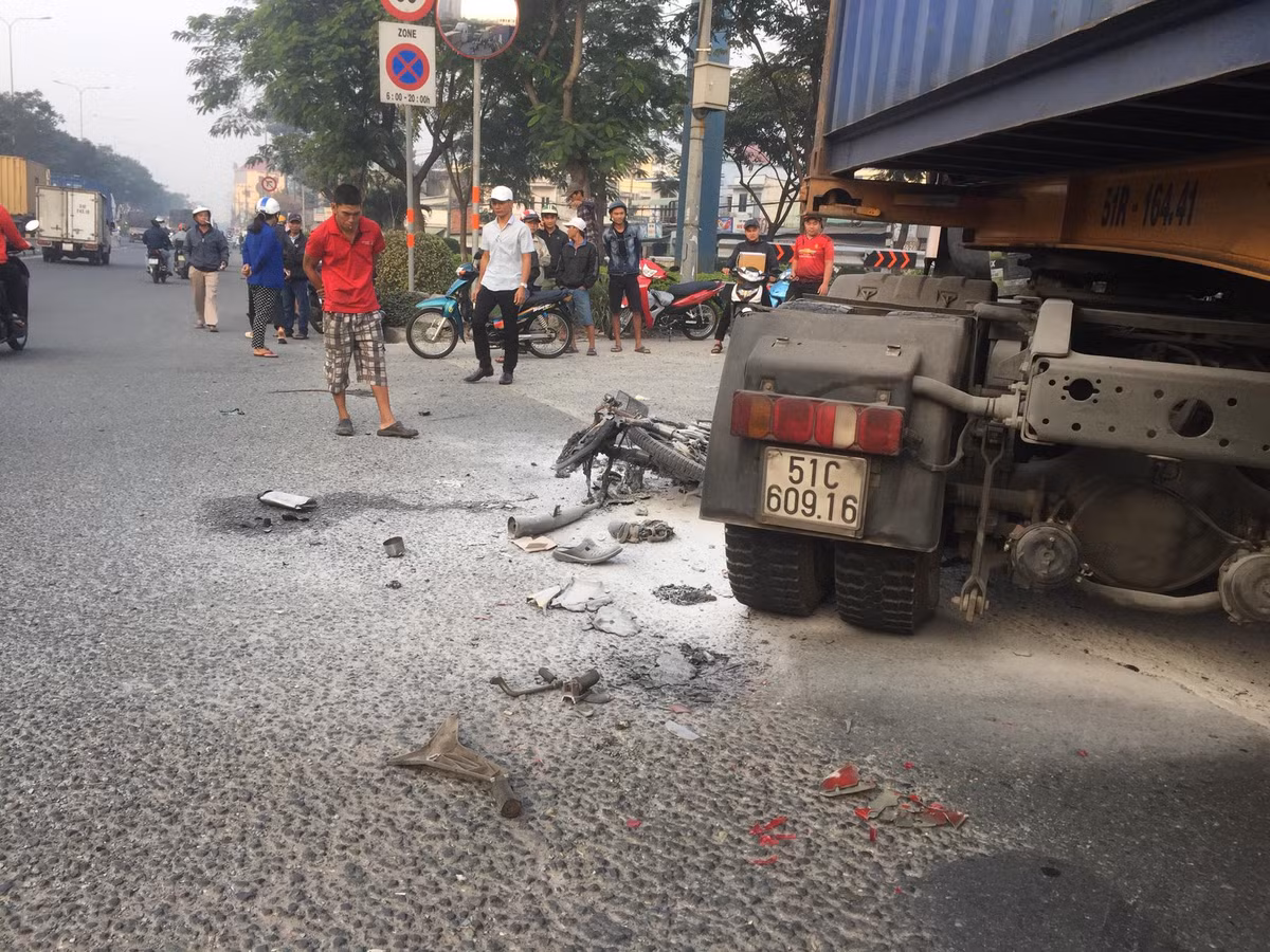 Xe may boc chay du doi duoi banh xe container o diem den tai nan giao thong-Hinh-3
