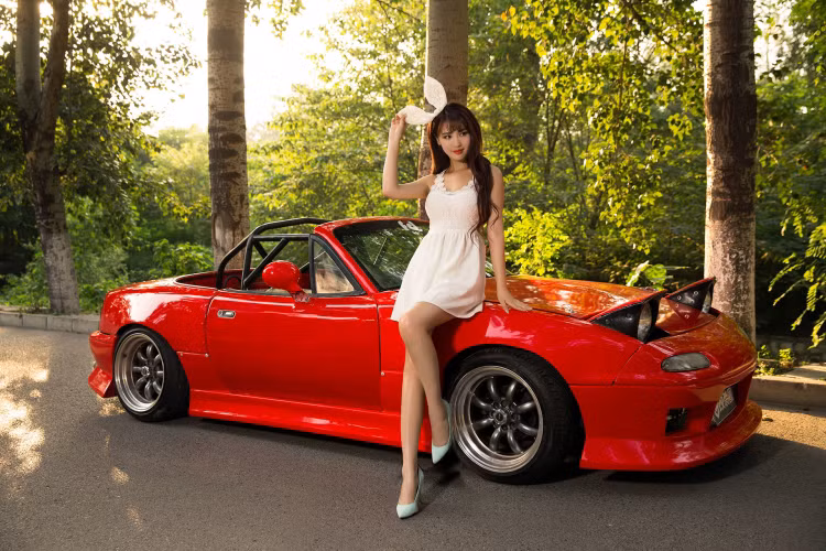 Chiếc Mazda MX-5 đỏ được độ cặp đèn pha mắt ếch "độc nhất vô nhị", bỗng trở nên vô cùng “xứng đôi vừa lứa” với một cô nàng người mẫu sở hữu vẻ đẹp trong sáng thuần khiết.