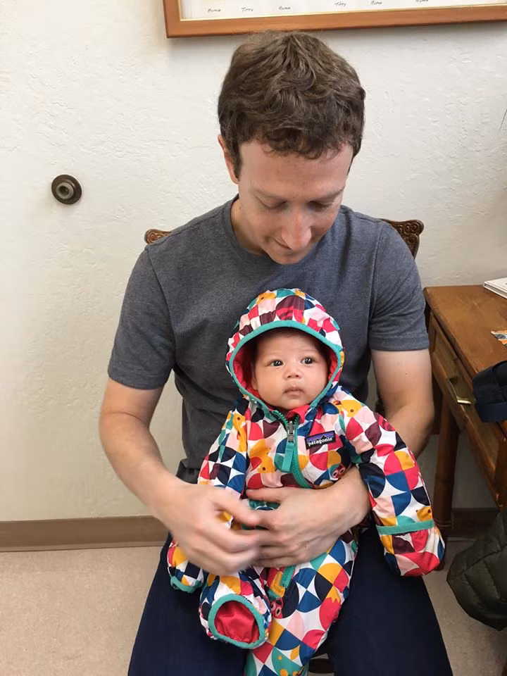 Ông chủ Facebook đưa con gái đi tiêm vaccine. Bé Max ngồi ngoan ngoãn trong lòng bố chờ được bác sĩ khám.