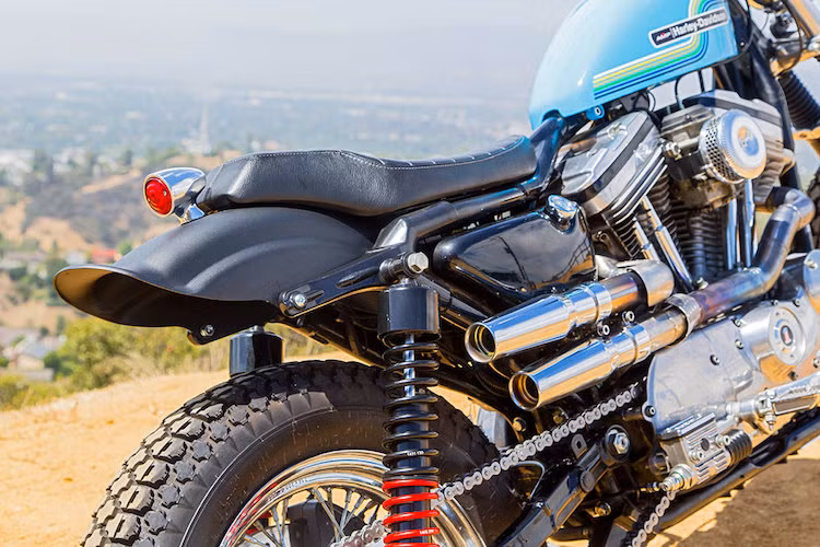 Phần khung ở đuôi chiếc 883 được Clint cắt gọn, sau đó lắp bộ chắn bùn Lowbrow Customs Tsunami. Biển số của chiếc xe được chuyển xuống bên phải bánh.