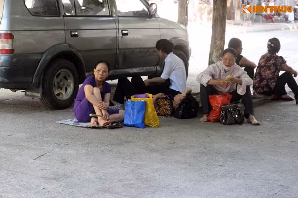 Nhiều phụ huynh mệt mỏi, tranh thủ ngả lưng ngay dưới gốc cây xanh đợi sĩ tử.