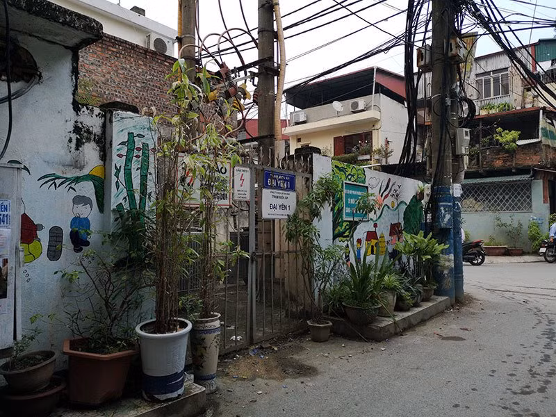 Bích họa cùng các chậu cây cảnh bao quanh trạm điện trong ngõ 173 phố Hoàng Hoa Thám (Ba Đình, Hà Nội) che khuất một phần tấm biển cảnh báo nguy hiểm.