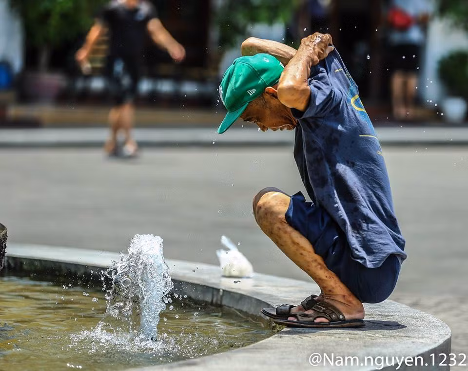 Còn với nhiều người, những điểm phun nước công cộng như ở Hồ Gươm (Hà Nội) là điểm tránh nắng tuyệt vời. Ảnh: Nam Nguyễn