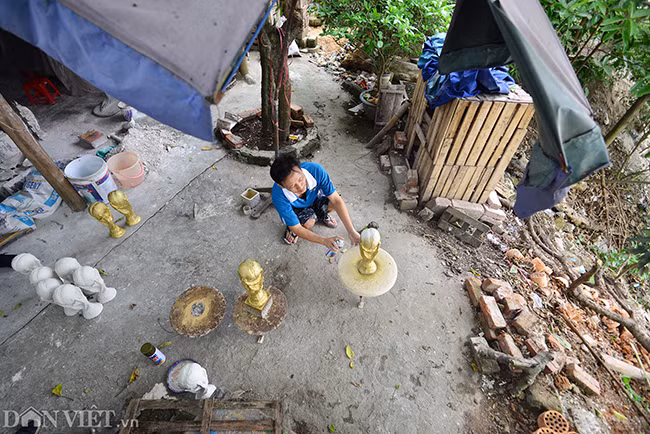 Trong khuôn viên xưởng sản xuất rộng khoảng 50m2 tại xã Bát Tràng, anh Vương Hồng Nhật cùng vợ là chị Nguyễn Thị Nga mấy ngày nay mải miết đẽo gọt những lô hàng cúp vàng FIFA để giao bán cho khách.