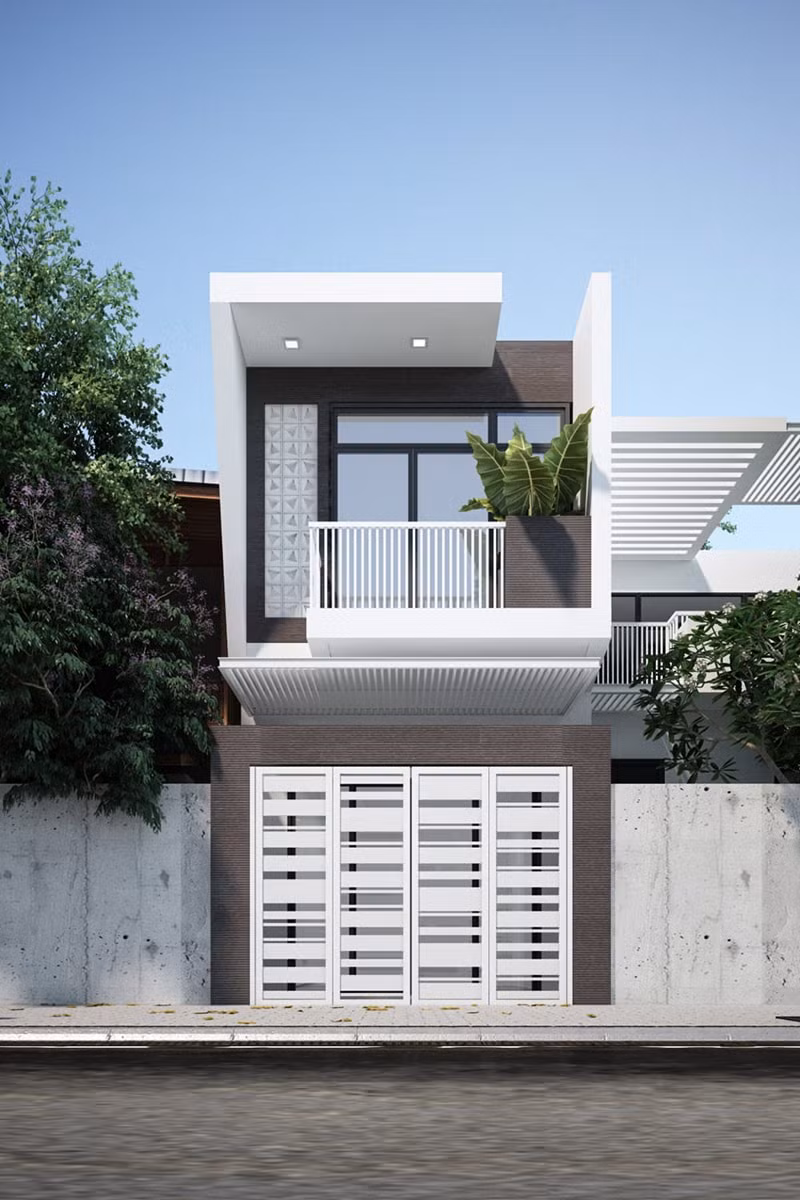Nhà ống 2 tầng gây ấn tượng với khối bê tông hình hộp vuông vức, khỏe khoắn. Màu trắng và nâu đậm bên ngoài giúp căn nhà trở nên thời thượng và hiện đại. Ảnh: Trananhgroup.