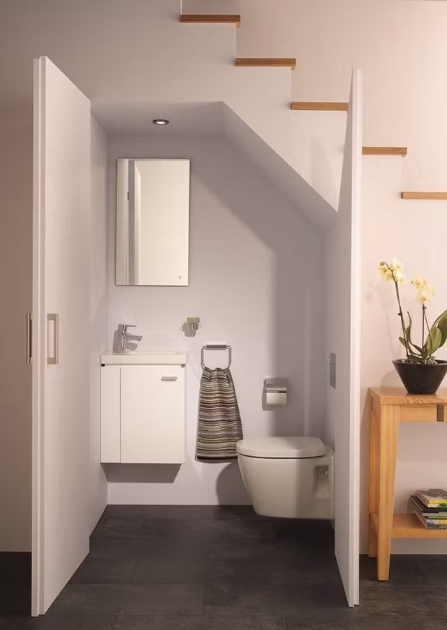 Khoảng trống dưới gầm cầu thang cũng có thể trở thành nhà vệ sinh phụ. Tuy nhiên, các thiết bị vệ sinh cần phải lưu ý về độ cao và chiều rộng, cần tạo đủ ánh sáng, tránh cảm giác tối tăm.
