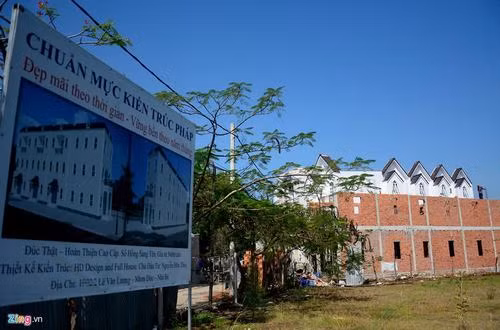 Một chủ đất đang thi công dãy nhà mới cạnh dãy nhà đã có người mua bên đường Lê Văn Lương. Cách công trình không xa là bảng quảng cáo với những mỹ từ rất thu hút.
