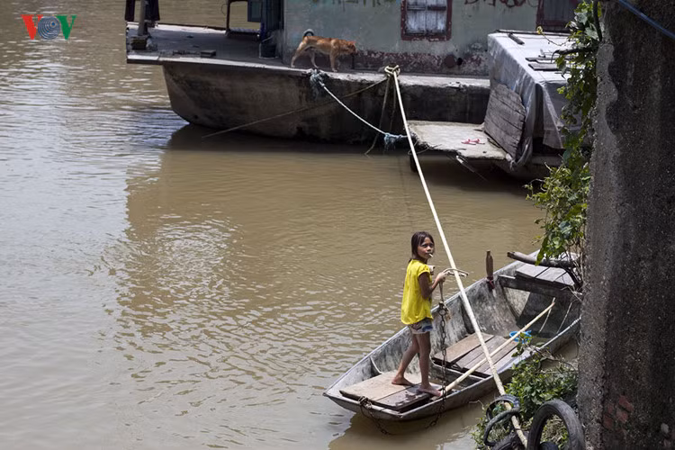 Mặc dù có nhiều nỗ lực của Nhà nước, các tổ chức xã hội, nhưng vẫn còn nhiều trẻ em, đặc biệt trẻ em gái vẫn chưa được đảm bảo những quyền lợi cơ bản như học tập, vui chơi, chăm sóc sức khỏe…Trong ảnh: Một bé gái phụ giúp cha mẹ làm nghề chèo đò chở khách trên sông Cầu, Bắc Giang.