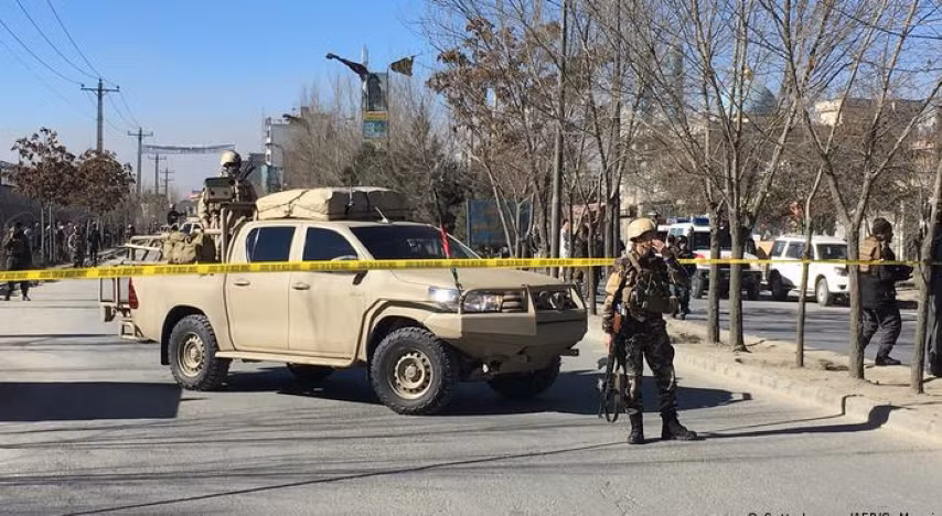 Các binh sĩ Mỹ nhiều ngày sau lái chiếc xe gắn súng phòng không chạy quanh sân bay để thị uy Taliban phía bên kia cánh cổng.