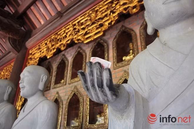 Không chỉ "sờ", khách tham quan thậm chí còn đặt tiền lên khắp tượng phật.