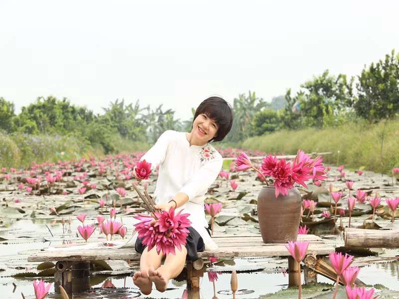 Diễm Quỳnh khoe nhan sắc mặn mà khi mặc áo dài chụp ảnh bên hoa súng.