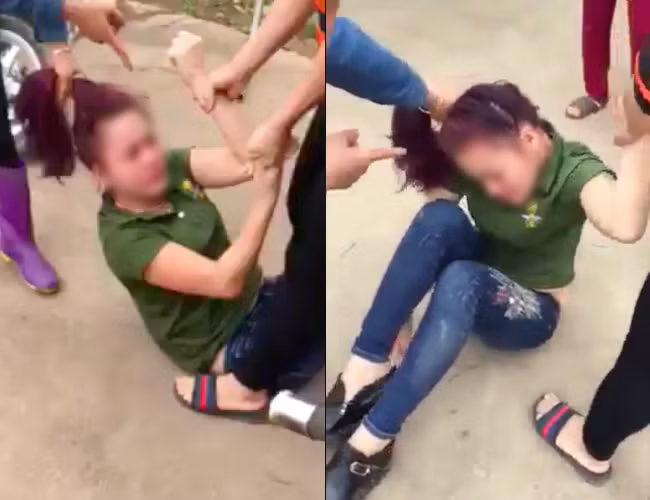 Cô nhân tình bị đánh ghen giữa đường sau khi gọi điện thách thức người vợ vào nửa đêm. Ảnh cắt từ clip.