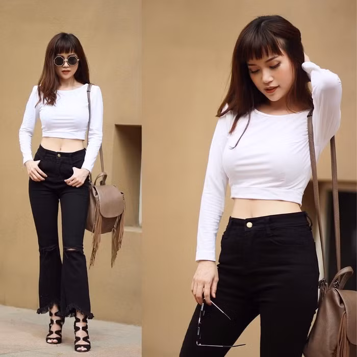 Với lợi thế vòng eo “con kiến” gợi cảm, Sĩ Thanh tạo dáng với thời trang như áo croptop, quần ống vẩy cạp cao, sandals dây đan.