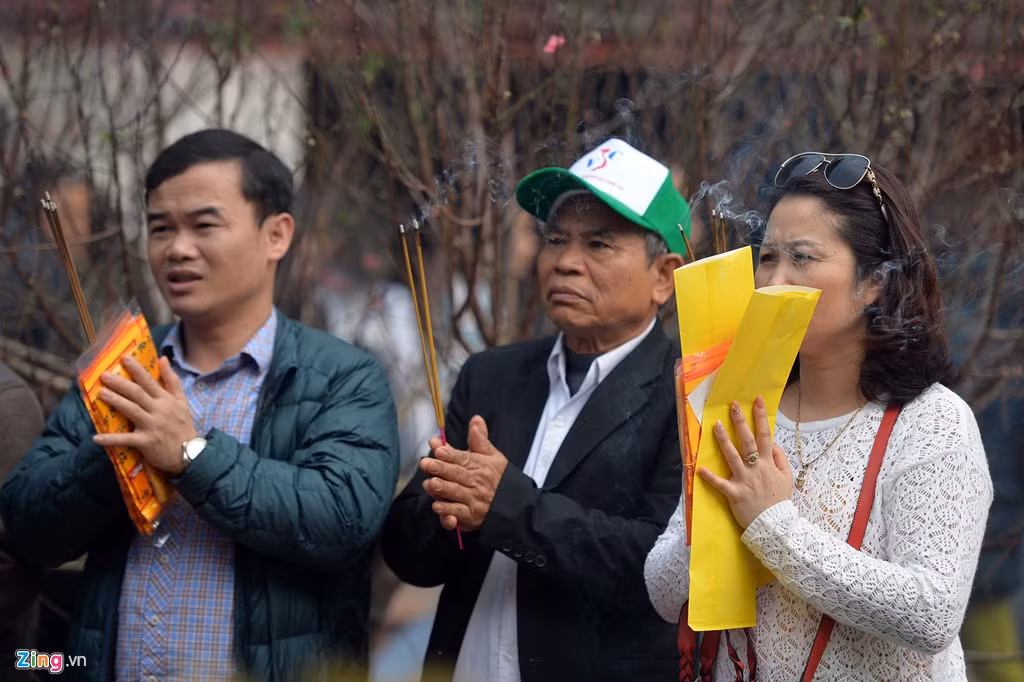 Bên ngoài sân, nhiều du khách đi theo đoàn đến tham quan và thắp hương.