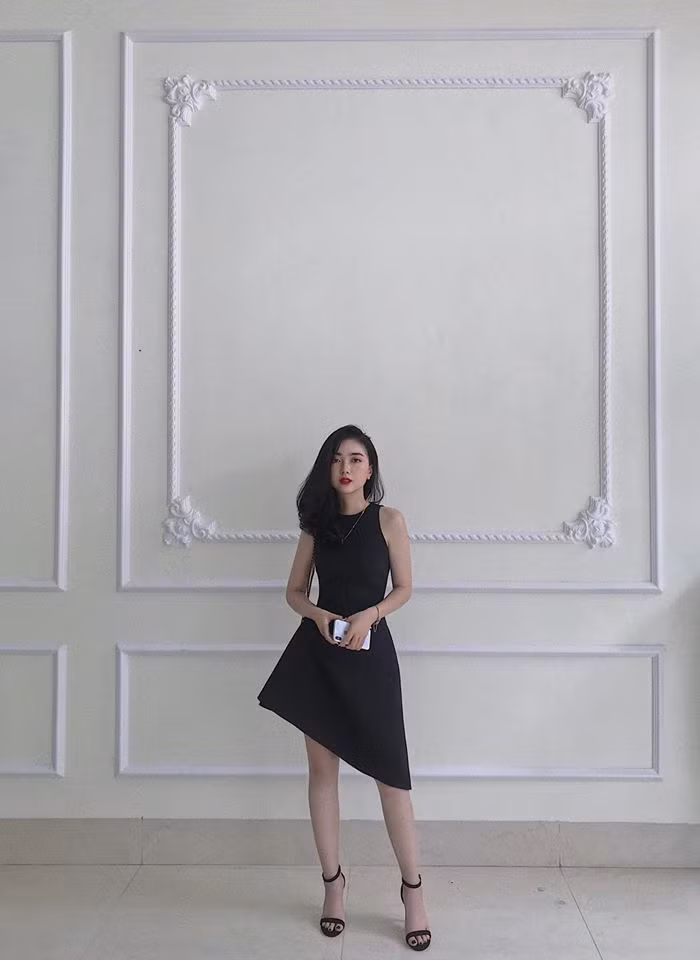 Chiếc đầm sát nách với phần chân váy lệch trông cực sang chảnh.