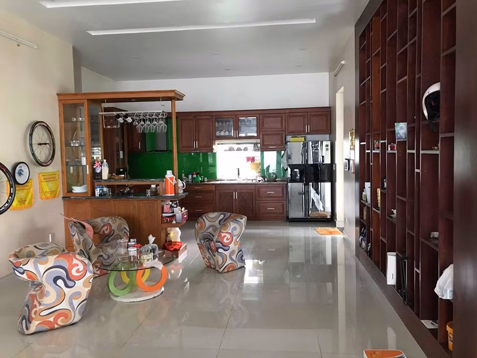 Nhà bếp bố trí bên cạnh, ngăn cách khu vực tiếp khách bằng vách ngăn gỗ.