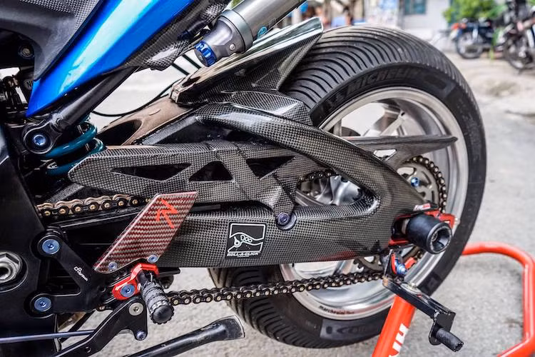 Sức mạnh của động cơ được truyền tới bánh sau qua sên EK Racing 3Dz và đĩa tải Driven. Ngay cả bộ chắn xích của xe cũng được làm từ sợi carbon, trong khi gắp nhôm nguyên bản của GSX-S1000 đã được ốp trang trí bên ngoài carbon. Hệ thống phuộc monoshock Nitron R2 khiến chiếc xe ổn định hơn nữa trên đường.