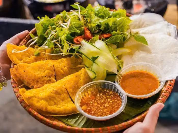 Không giống bánh xèo miền Trung thường thấy, bánh xèo Lý Sơn nhỏ hơn, nhân chủ yếu là mực, tôm, ăn kèm rau sống và nước chấm đậm đà, tạo nên hương vị riêng biệt, rất "chất đảo" . Ảnh Internet