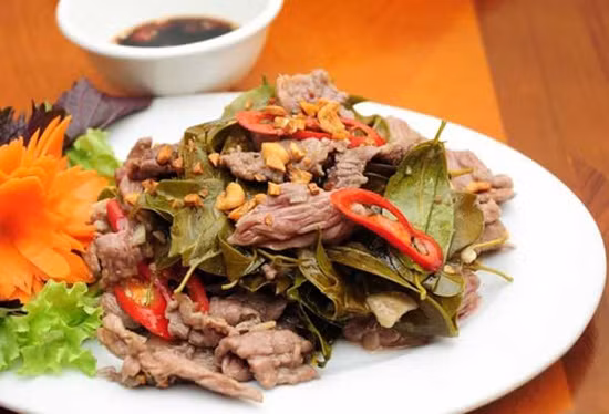 Thịt trâu nấu lá lồm: Thịt trâu thái miếng nhỏ cho vào nồi đất hầm kỹ cùng với lá lồm giã nhỏ (lá có vị chua), gạo tấm cho đến khi gạo nở bung, sánh đặc lại. Khi chín, thịt trâu dai, thấm đượm vị chua của lá đồm, cùng với mùi thơm dễ chịu của gạo. Đây là món đặc sản Hòa Bình bạn nhất định phải thử khi tới mảnh đất này. Ảnh: Danviet.