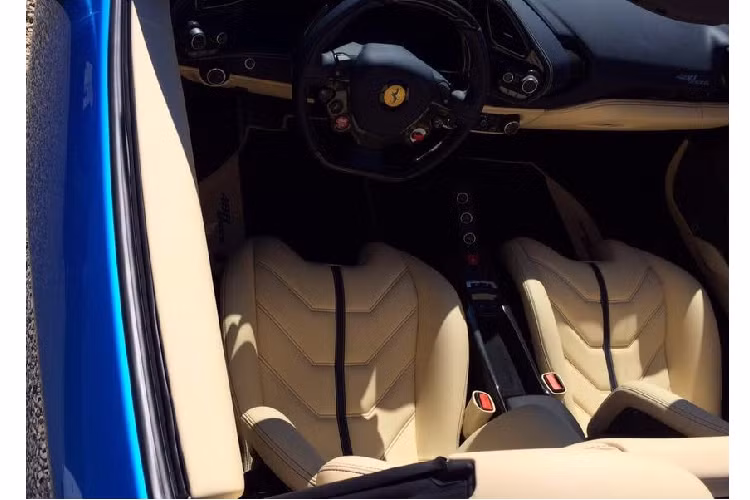 Trái ngược sự sặc sỡ của ngoại thất, nội thất của chiếc Ferrari 488 Spider có màu kem sáng khá nhẹ nhàng và sang trọng, điểm xuyết bởi sọc kẻ màu đen ở chính giữa ghế ngồi. Ghế ngồi của xe là loại ghế đua làm từ sợi carbon. Đai an toan màu xanh dương.
