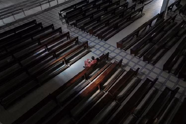 Một tín hữu ngồi một mình tại Nhà thờ Notre-Dame des Victoires trong thánh lễ chủ nhật, tại Dakar, Sénégal ngày 22/3. 