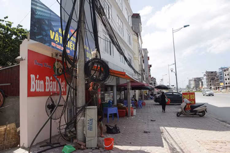 Những tuyến đường mời mở, đầu tư hàng triệu đô la nhưng vẫn tồn tại những ngôi nhà kì dị. Có người, chỉ cần còn một bức tường là có thể kinh doanh được chứ không bán cho nhà phía trong. Trong ảnh là đoạn Nhật Tân - Xuân La - Bưởi - Cầu Giấy dài 6,4 km có tổng mức đầu tư 304,7 triệu USD (tương đương 6,4 nghìn tỷ đồng). 