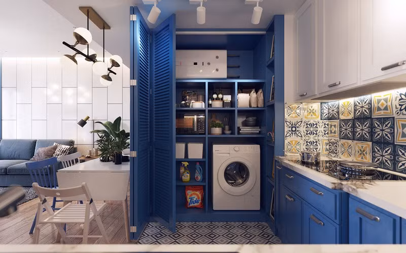 Máy giặt cùng các dụng cụ nấu nướng được giấu gọn gàng trong tủ âm tường.